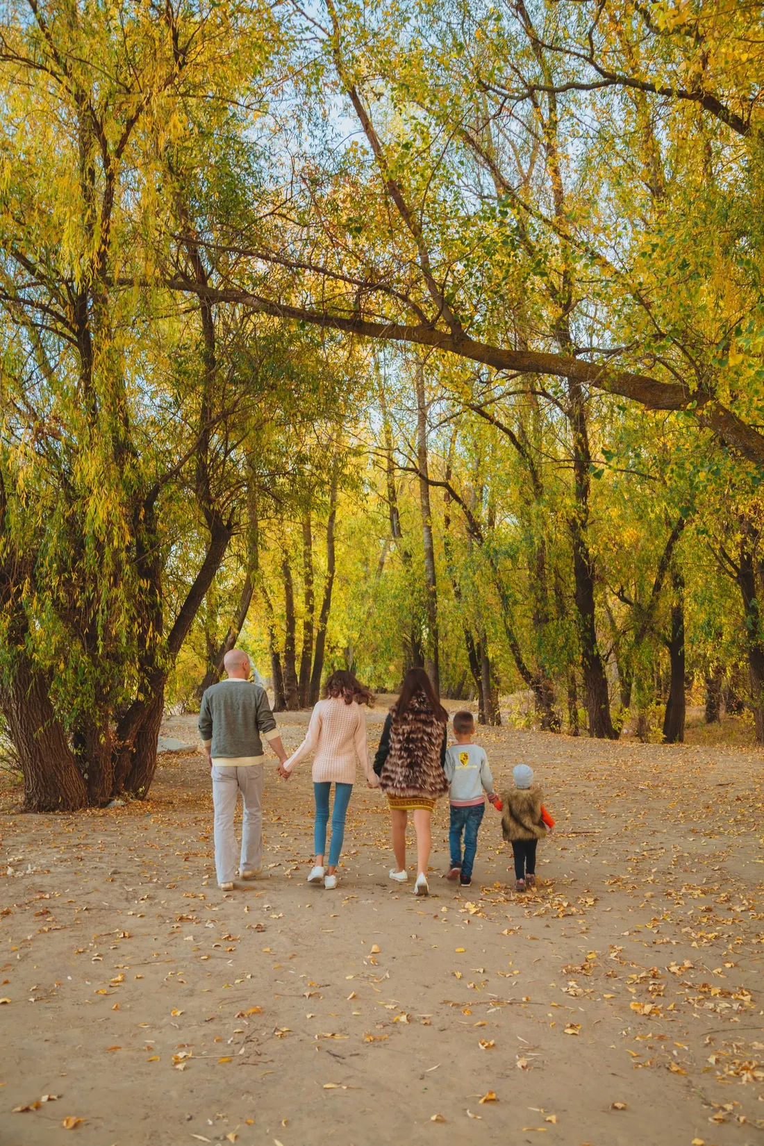 A family walking together through an autumn park